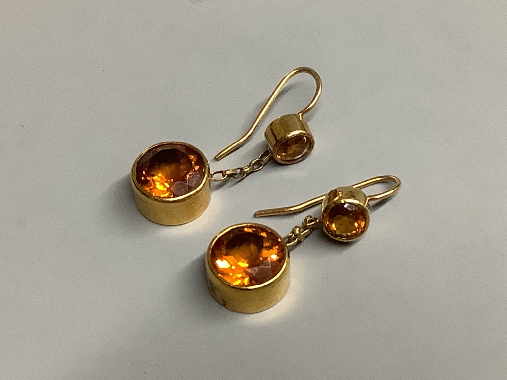 A pair of yellow metal and two stone citrine set drop earrings